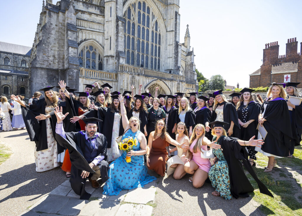 Students from University Centre Sparsholt celebrate their graduation in front of Winchester Cathedral