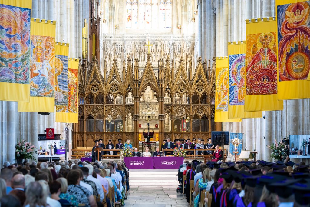University Centre Sparsholt graduation ceremony inside Winchester Cathedral with academic staff seated at the front and graduates in caps and gowns