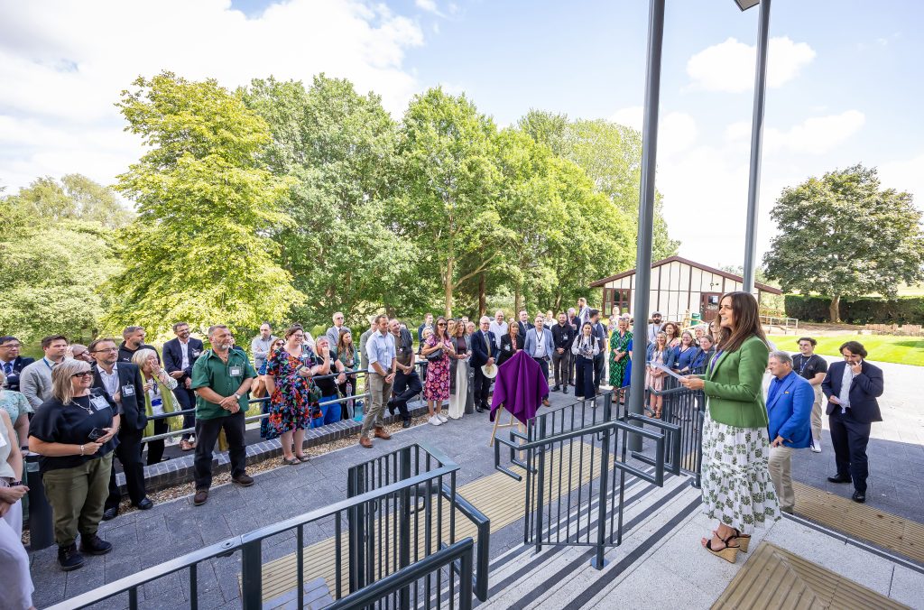 Group gathered outside the University Centre Sparsholt Research and Science Centre for the official opening event, standing looking at CEO of Sparsholt College Group.