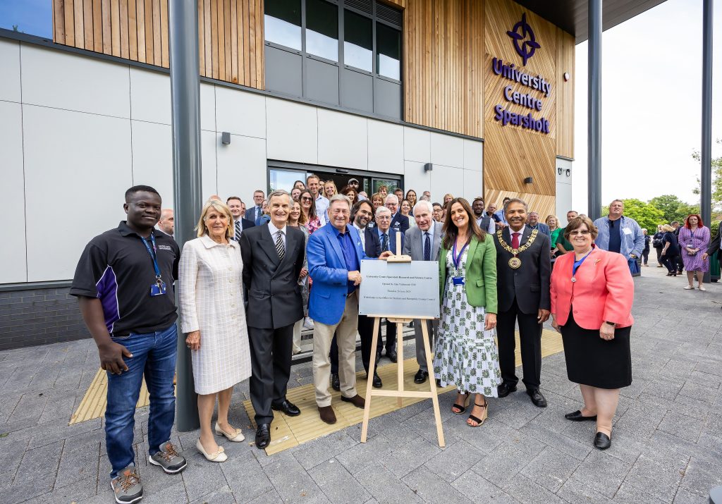 Group gathered outside the University Centre Sparsholt Research and Science Centre for the official opening event, standing near the commemorative plaque.