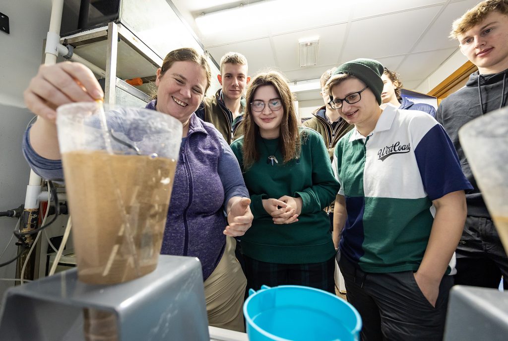 Lecturer running a demonstration using beakers