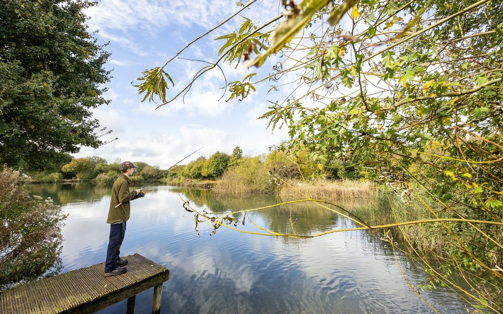 Student fishing in lake