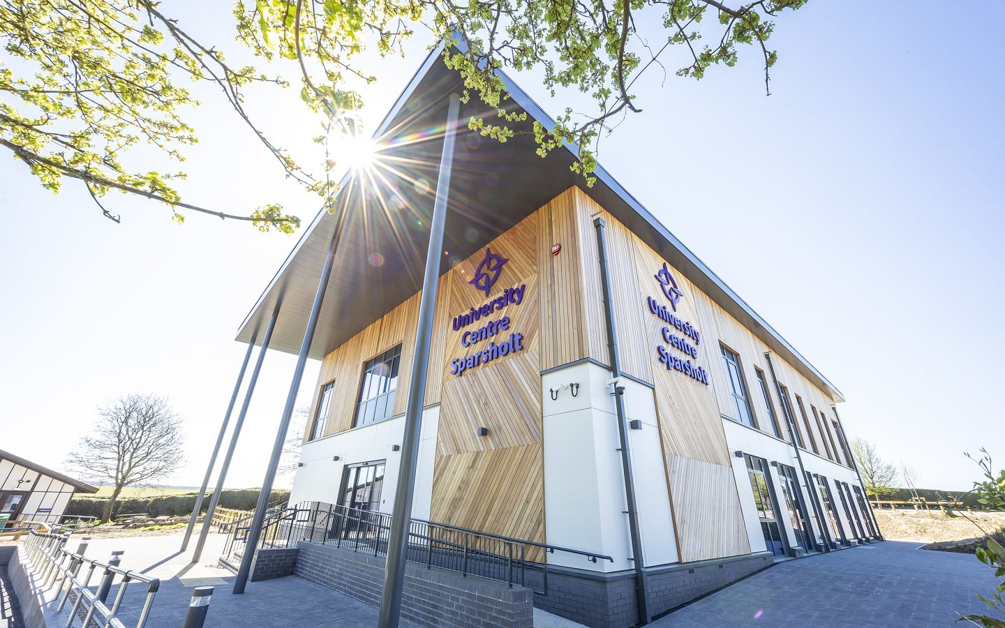 The modern, cladded UCS Research and Science building shrouded in sun