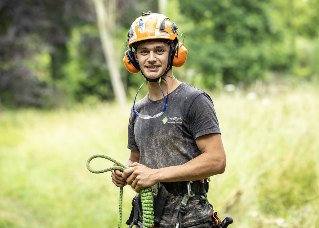 Arboriculture students wearing PPE smiles to camera